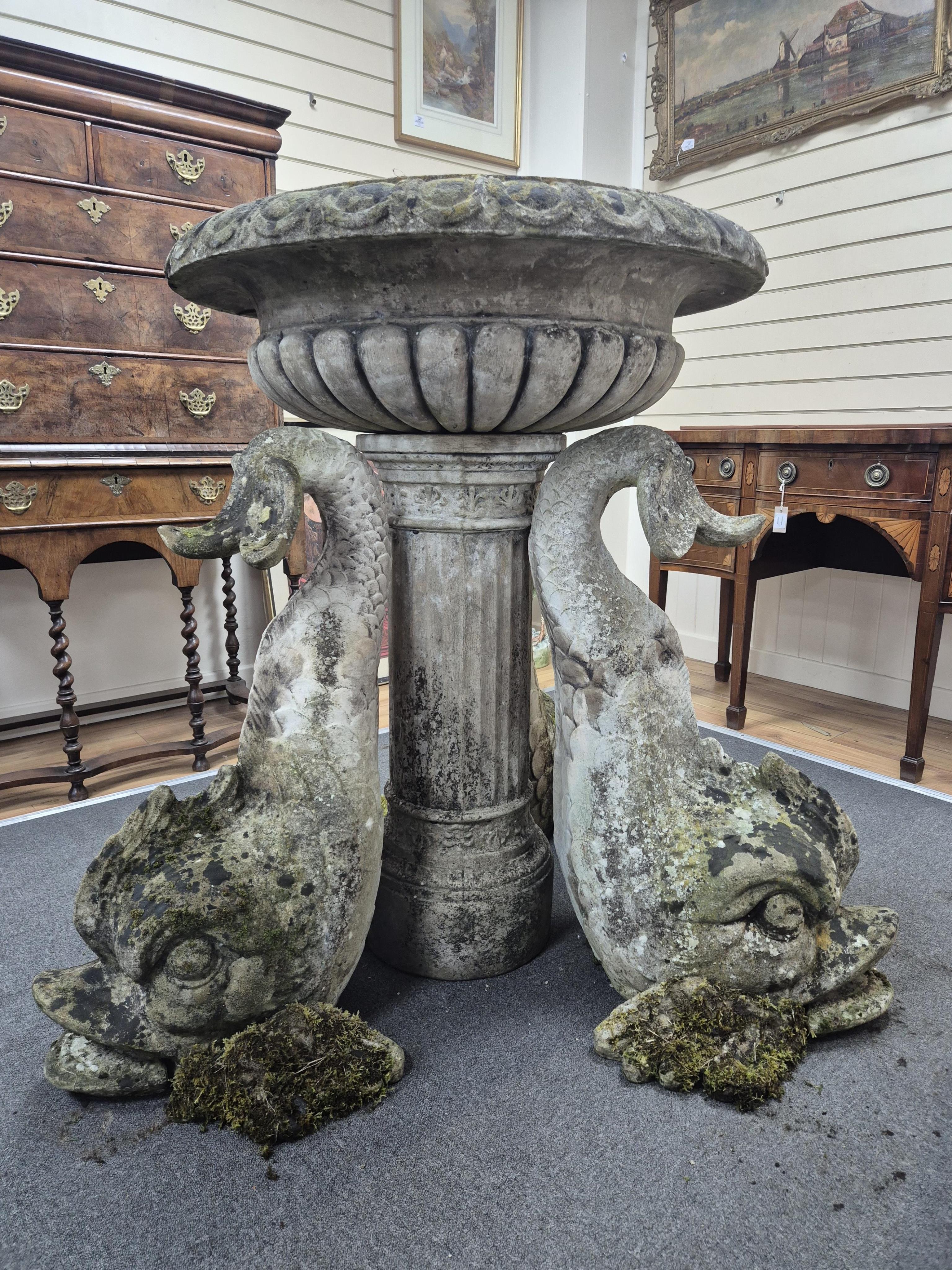 A reconstituted stone bird bath